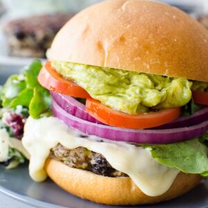 Healthy black bean burgers on a bun with toppings.