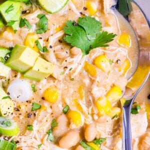 Instant Pot white chicken chili with cilantro and avocado garnish.