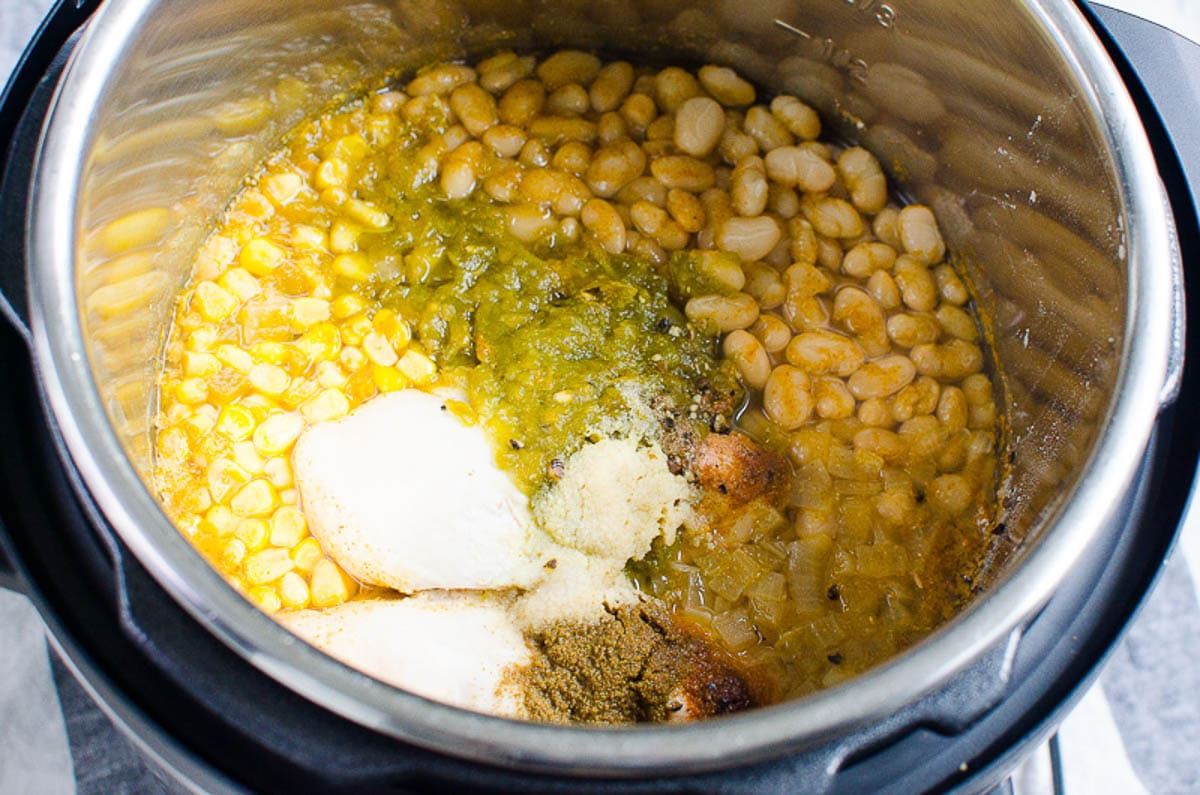 Instant Pot White Chicken Chili ingredients inside pressure cooker.