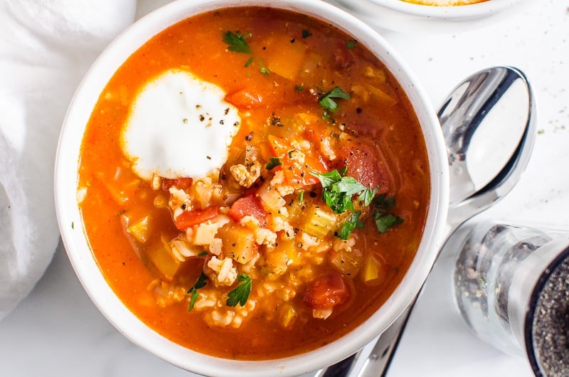 Instant Pot Stuffed Pepper Soup with dollop of yogurt, spoons and pepper