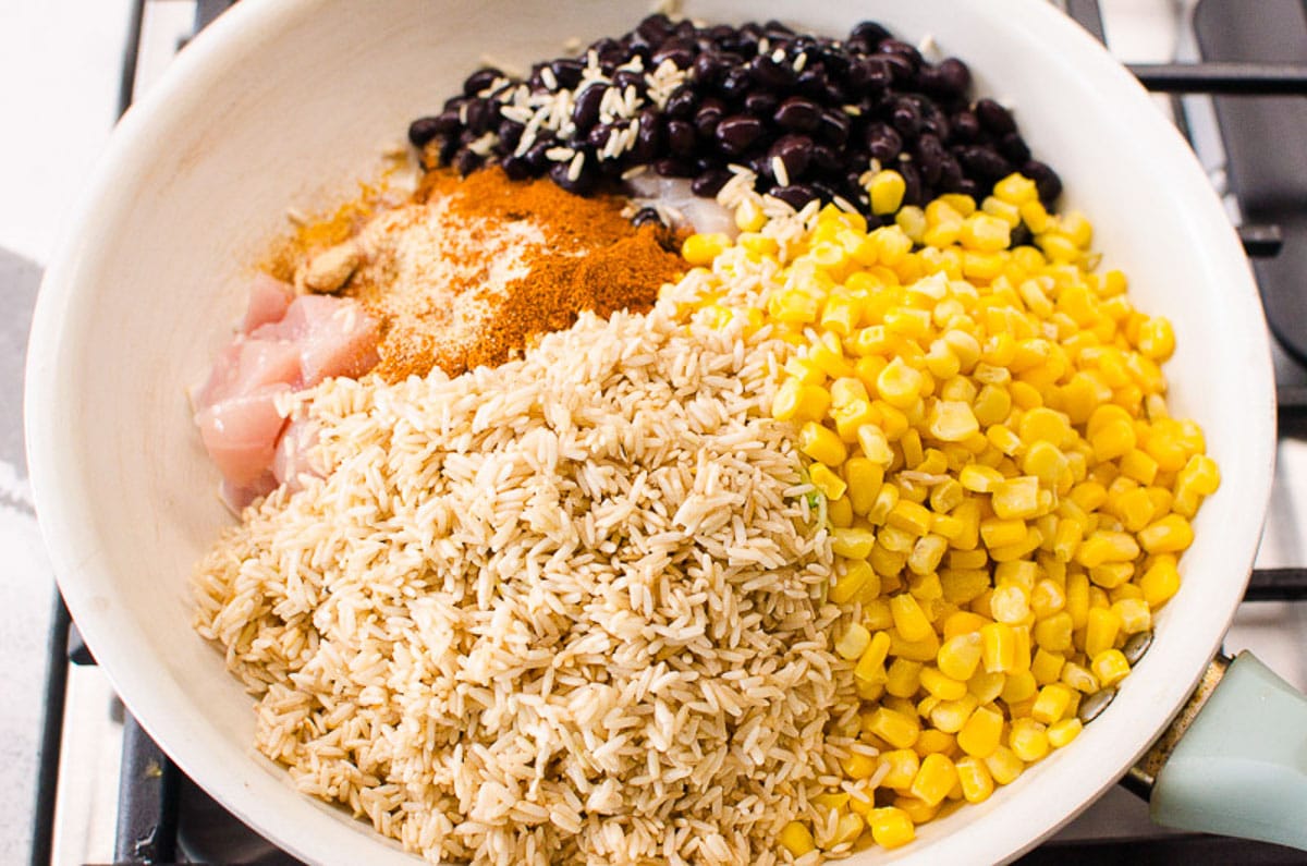 Rice, black beans, corn, chicken and seasonings in skillet.