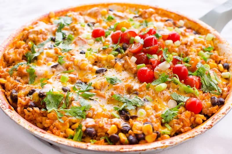 Chicken Burrito Skillet garnished with cilantro, cherry tomatoes and green onion