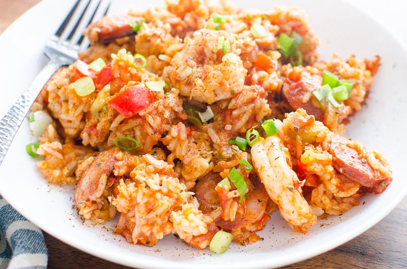 Shrimp, rice, sausage and peppers on plate. 