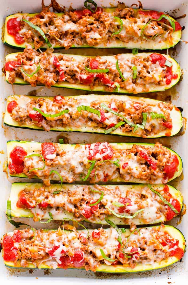 Zucchini Boats recipe in baking dish garnished with basil and pepper
