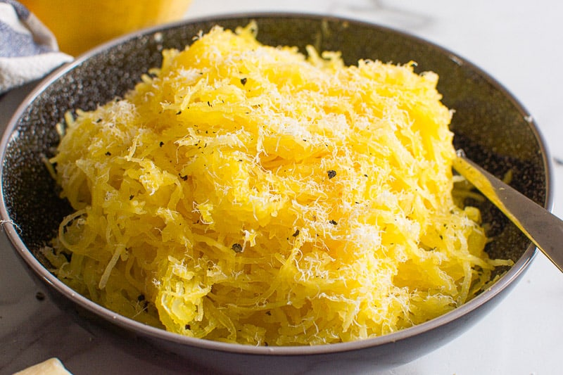 Instant Pot Spaghetti Squash in black bowl garnished with parmesan cheese