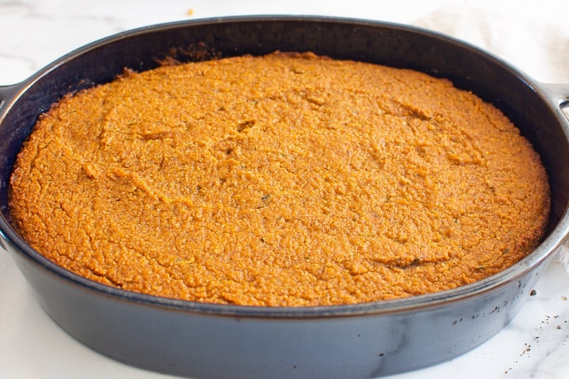 Healthy pumpkin cake cooling in a cake pan.