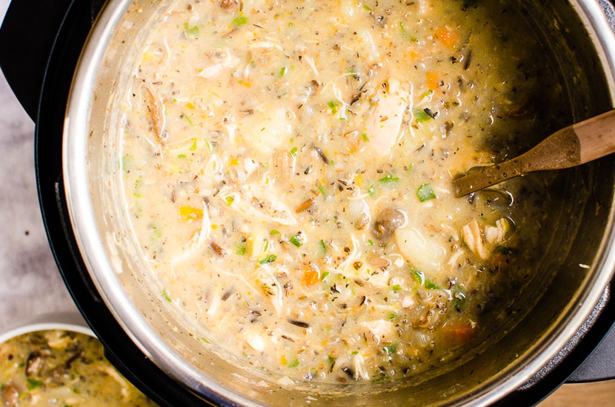 Chicken Wild Rice Soup in Instant Pot and ladle inside