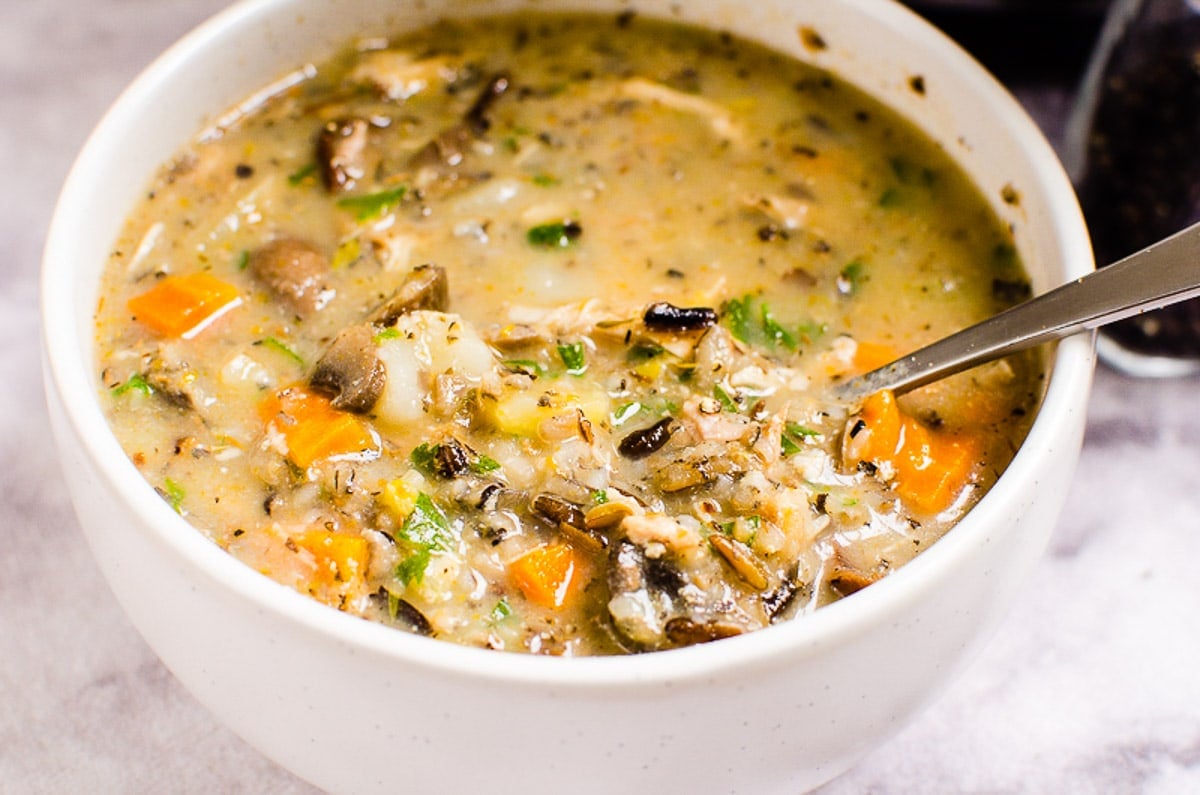 Instant Pot Chicken Wild Rice Soup in white bowl with a spoon