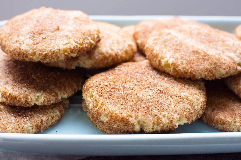 Gluten free snickerdoodles on blue platter.