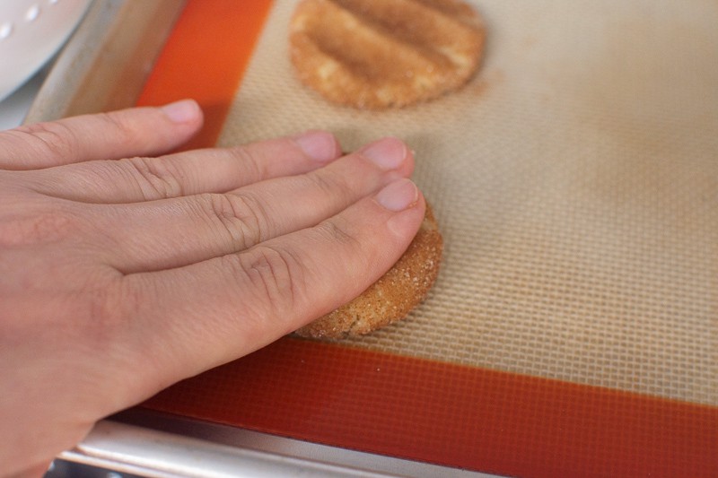 using hand to flatten snickerdoodle recipe