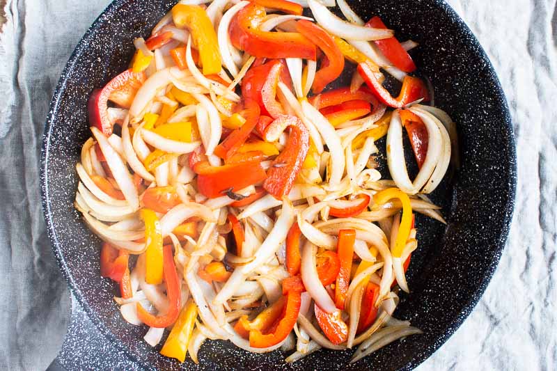 sauteed onions and peppers in skillet