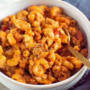 Instant Pot goulash in a bowl with a spoon.