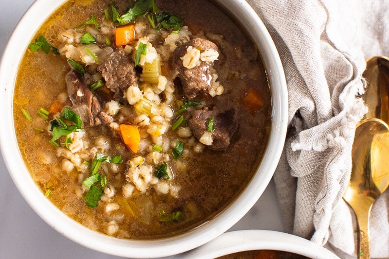 Instant Pot Beef and Barley Soup garnished with parsley