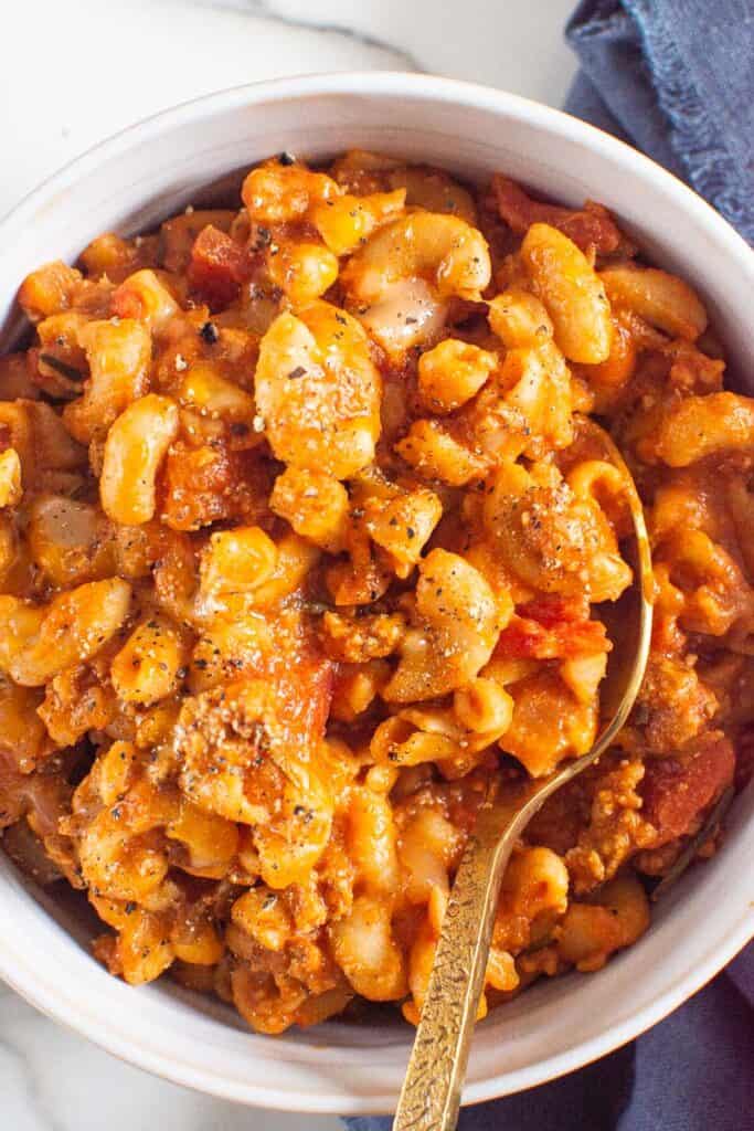 Instant Pot goulash with ground turkey, pasta and diced tomatoes in a serving bowl.