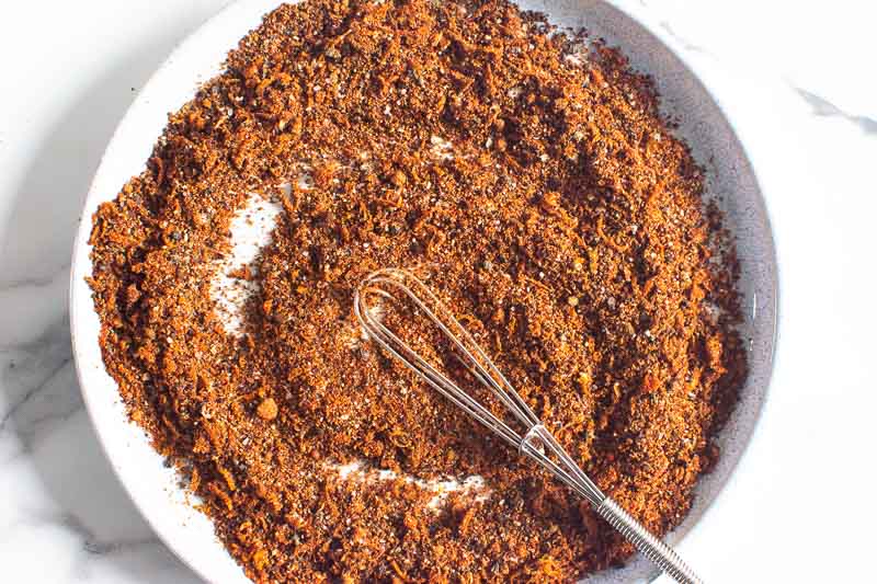 mixed spices on a plate with a whisk