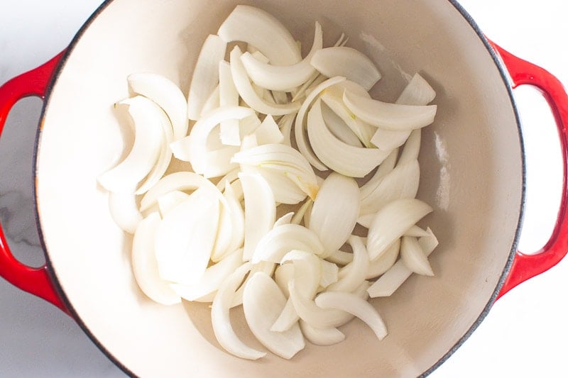 sliced white onion inside red pot