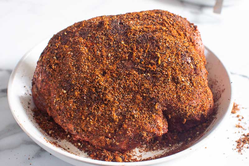 sirloin tip roast coated in spices on white plate