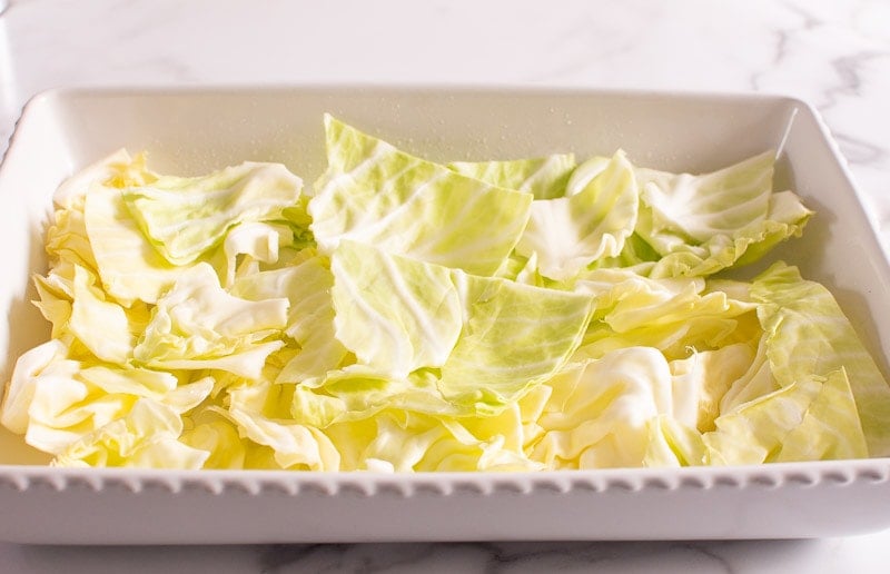 layered cabbage leaves in white baking dish