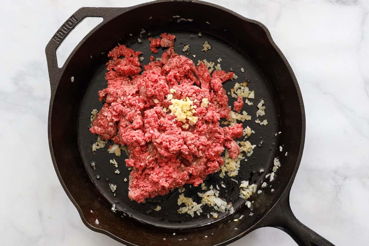 Steps to make Ground Beef Tacos, including cooking the ground beef with browned onions and minced garlic in a skillet.