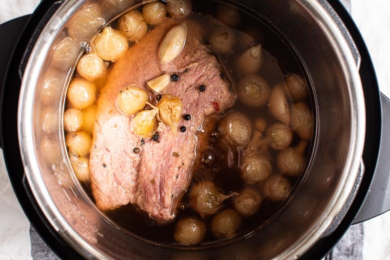 cooked brisket with onions, garlic and peppercorns in instant pot