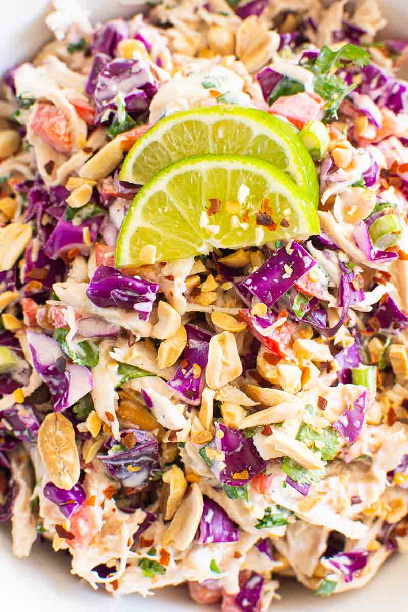 Closeup of Thai chicken salad garnished with lime.