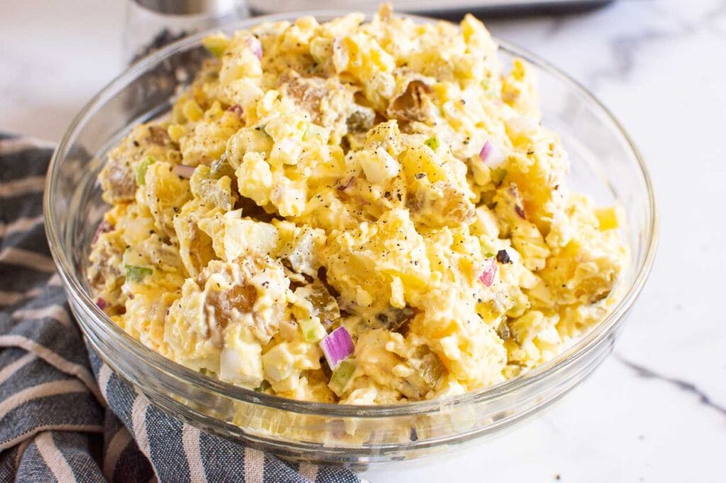 instant pot potato salad garnished with red onion