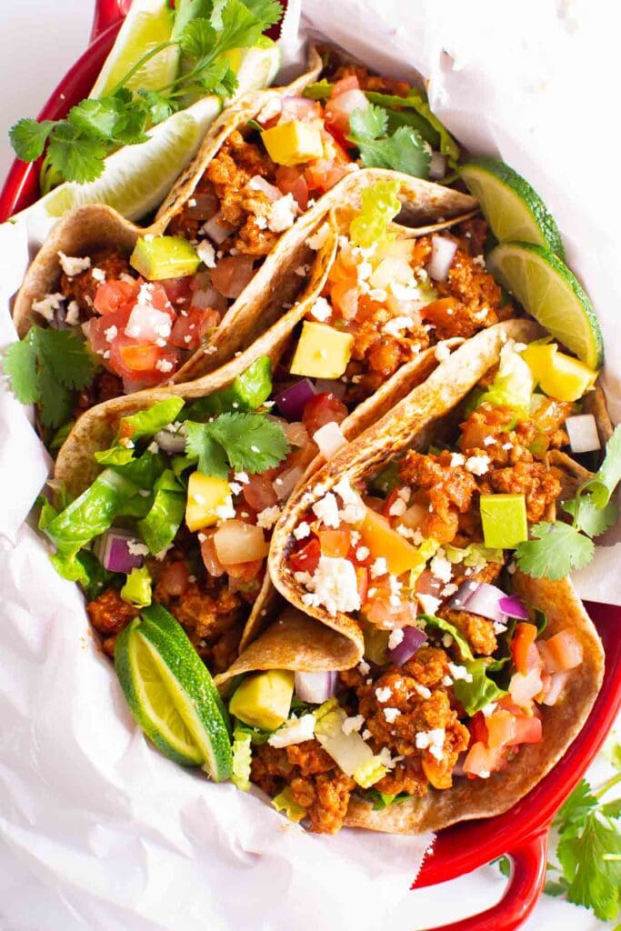 ground turkey tacos recipe in red dish and fixins