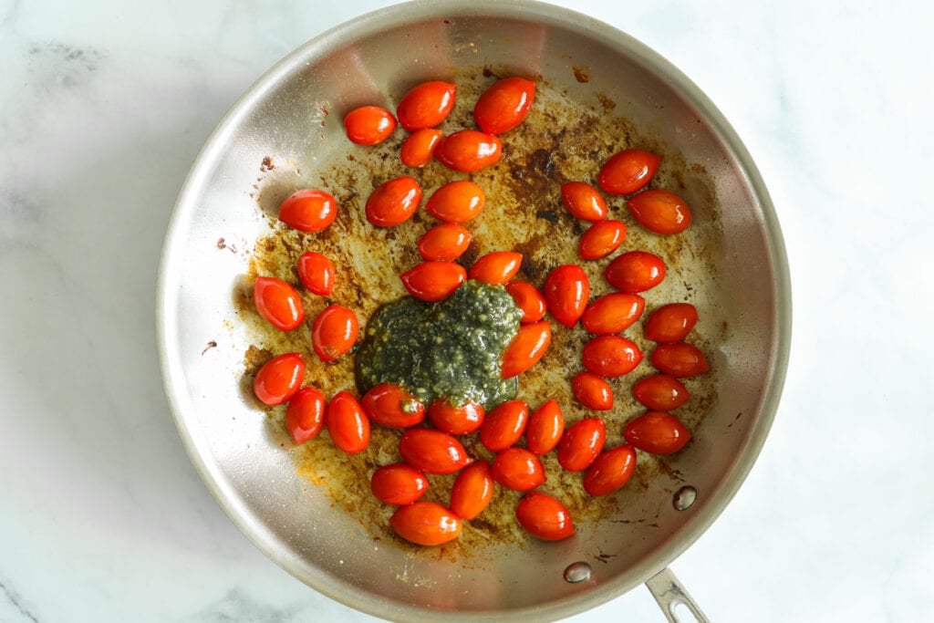 Steps to make Pesto Chicken, including blistering the cherry tomatoes and mixing in the basil pesto.