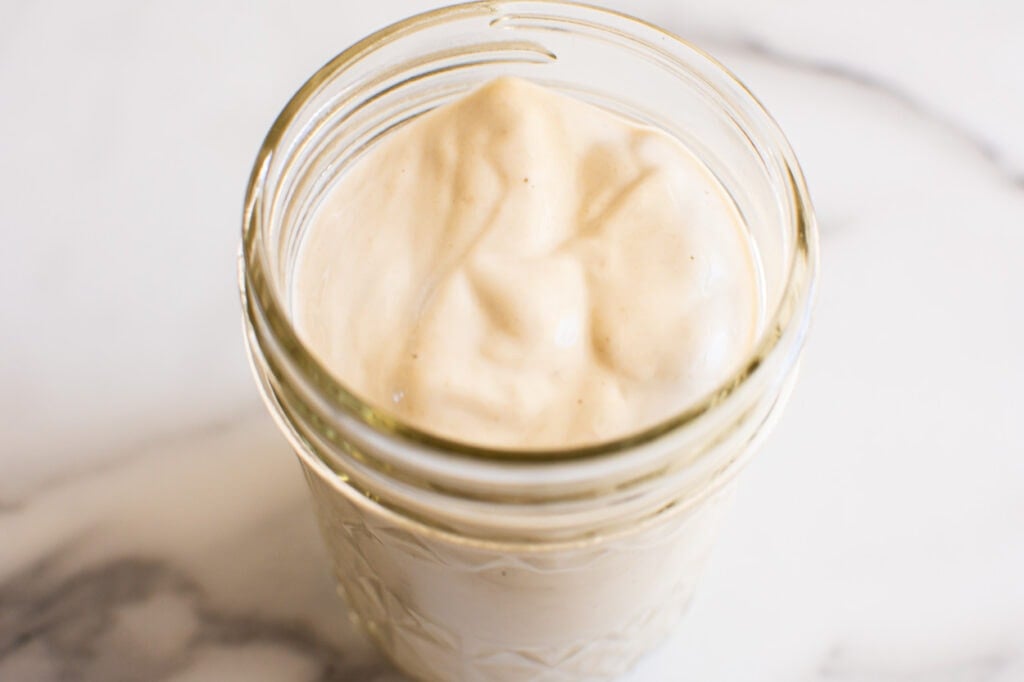 tahini sauce in jar for quinoa falafel