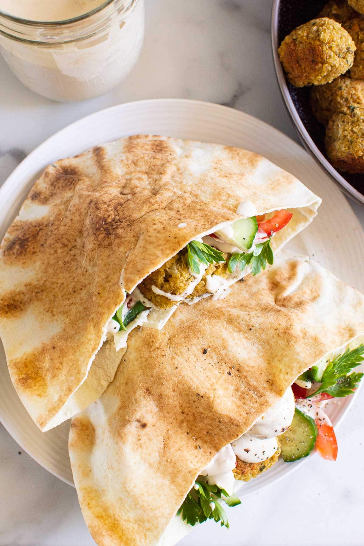 plated quinoa falafel meal idea in pita pockets with tahini sauce