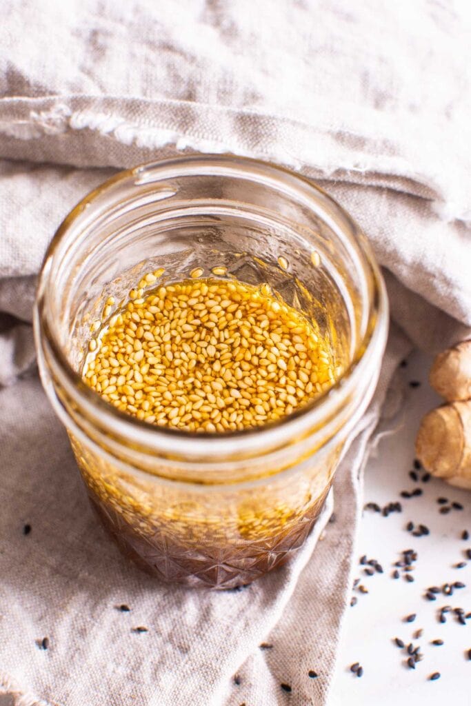 asian salad dressing in jar with sesame seeds