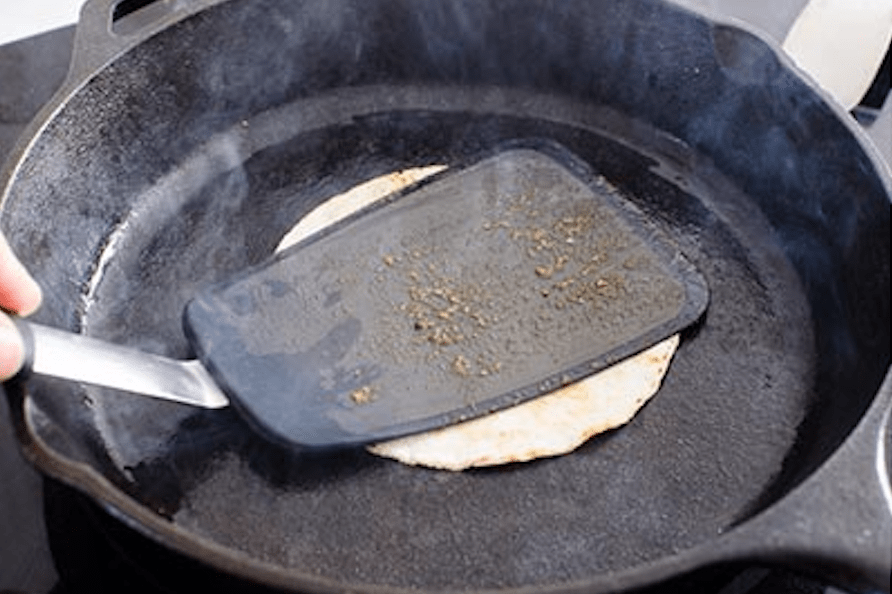warming up tortilla on cast iron skillet