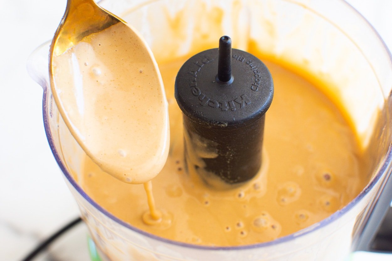 easy peanut sauce dripping from a spoon