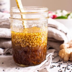 Asian salad dressing in mason jar with fresh ginger.