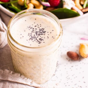 poppy seed dressing with salad in background