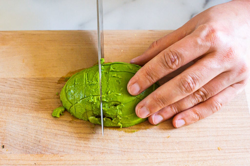 slice avocado with knife vertically
