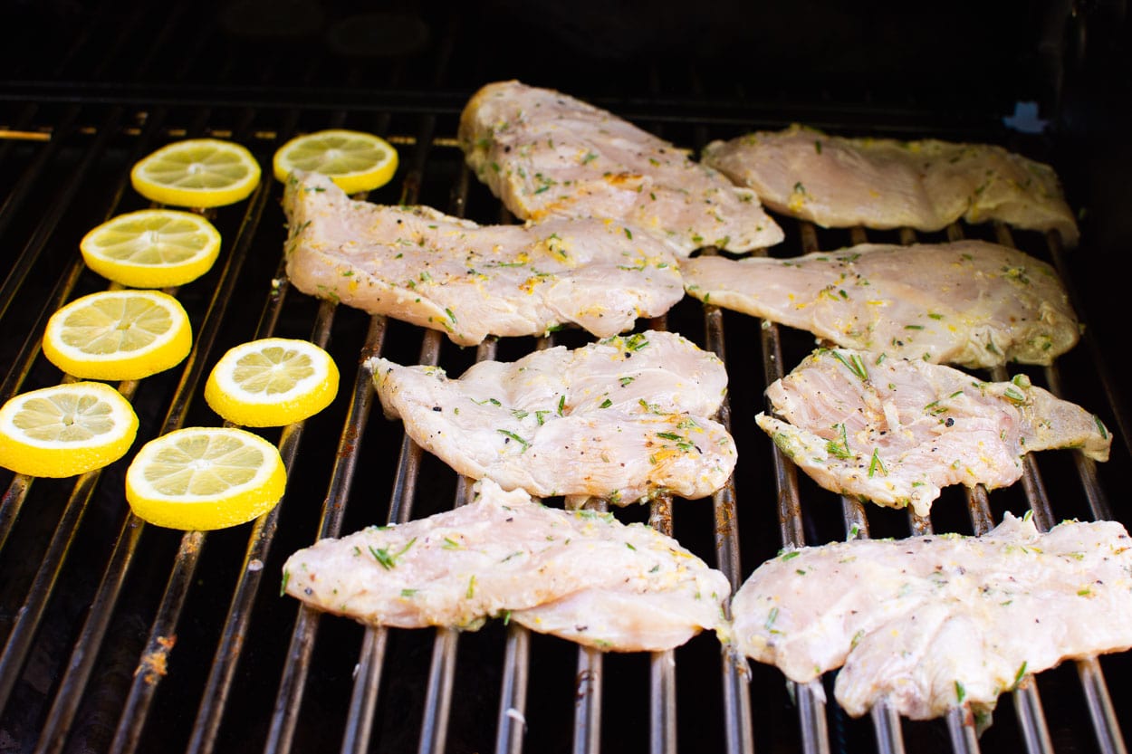 lemon slices and chicken breasts on the grill