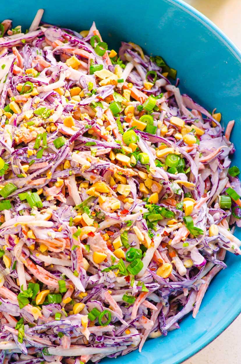 Close up of peanut slaw in a blue bowl.