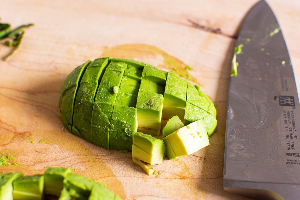 Diced avocado on cutting board.