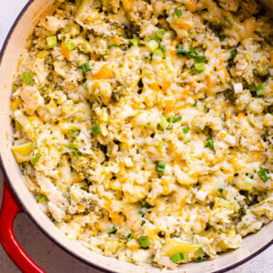 Healthy chicken and rice casserole with broccoli in red Dutch oven.