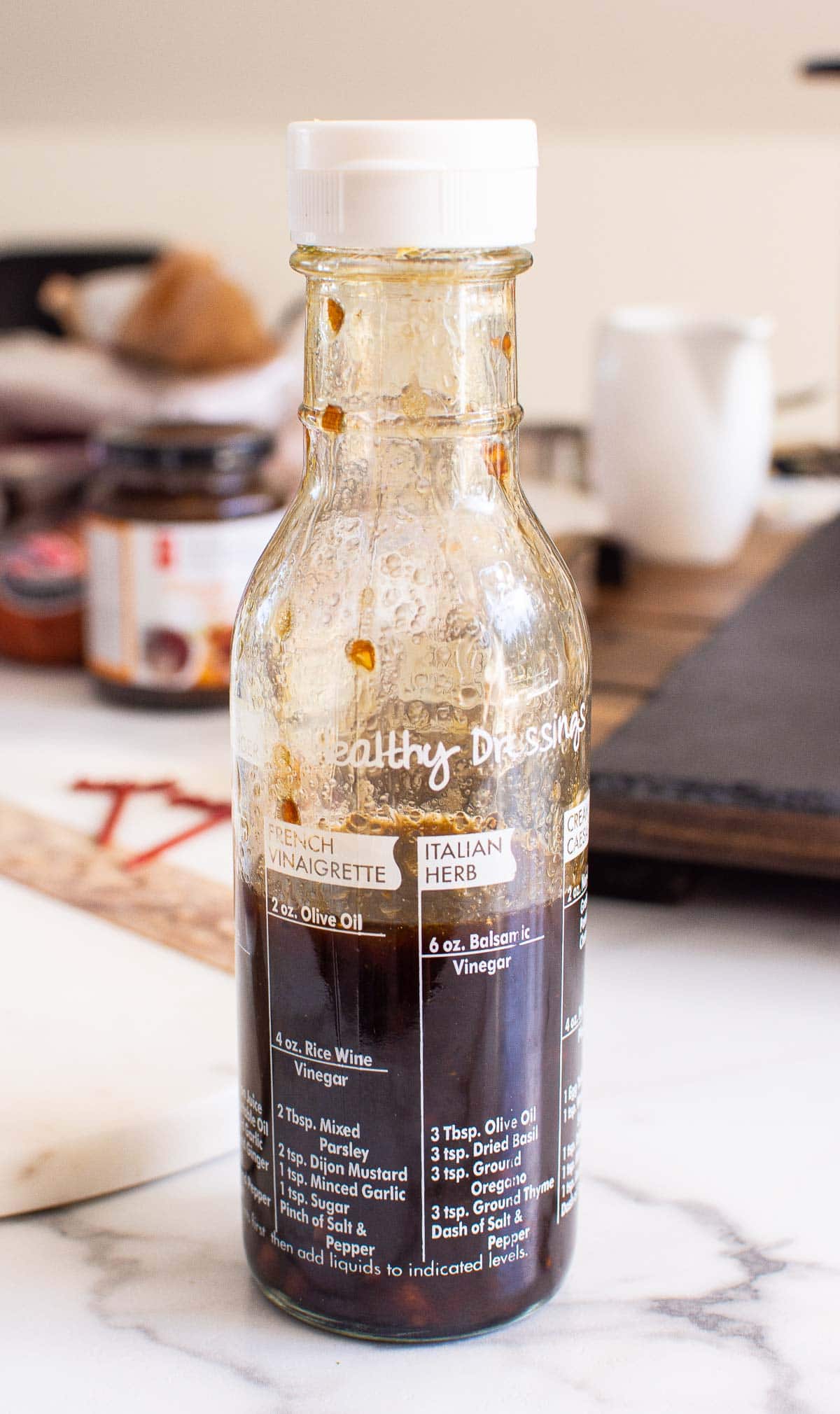 A close up of a bottle of garlic olive oil dip with balsamic vinegar.