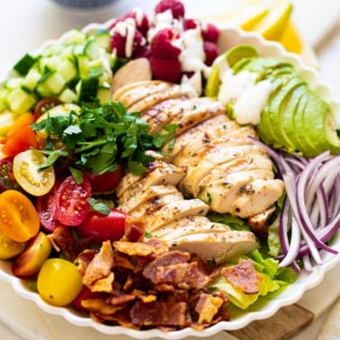 Grilled chicken salad recipe with poppy seed dressing in a bowl.