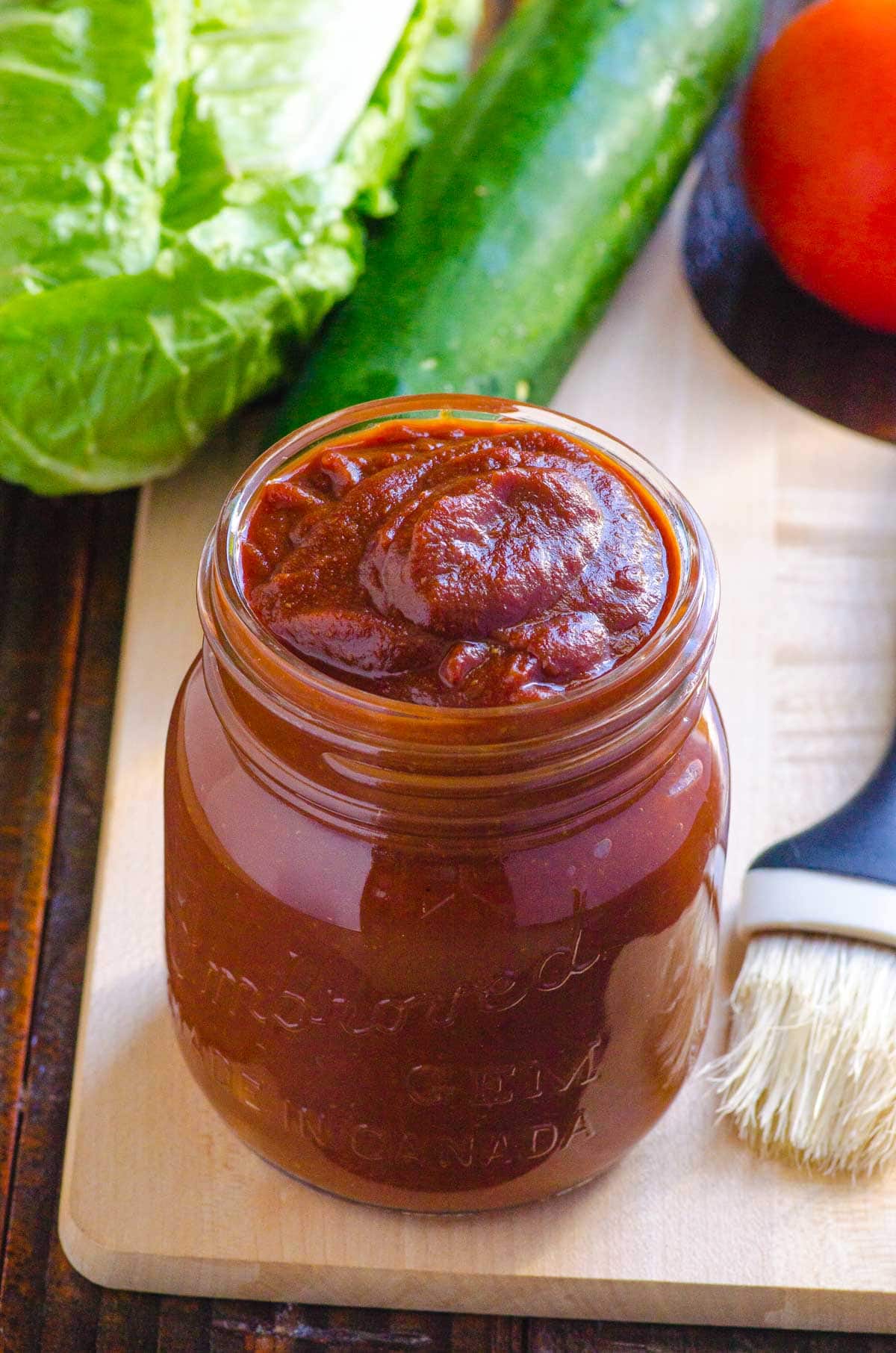 Healthy bbq sauce recipe with basting brunch on cutting board.