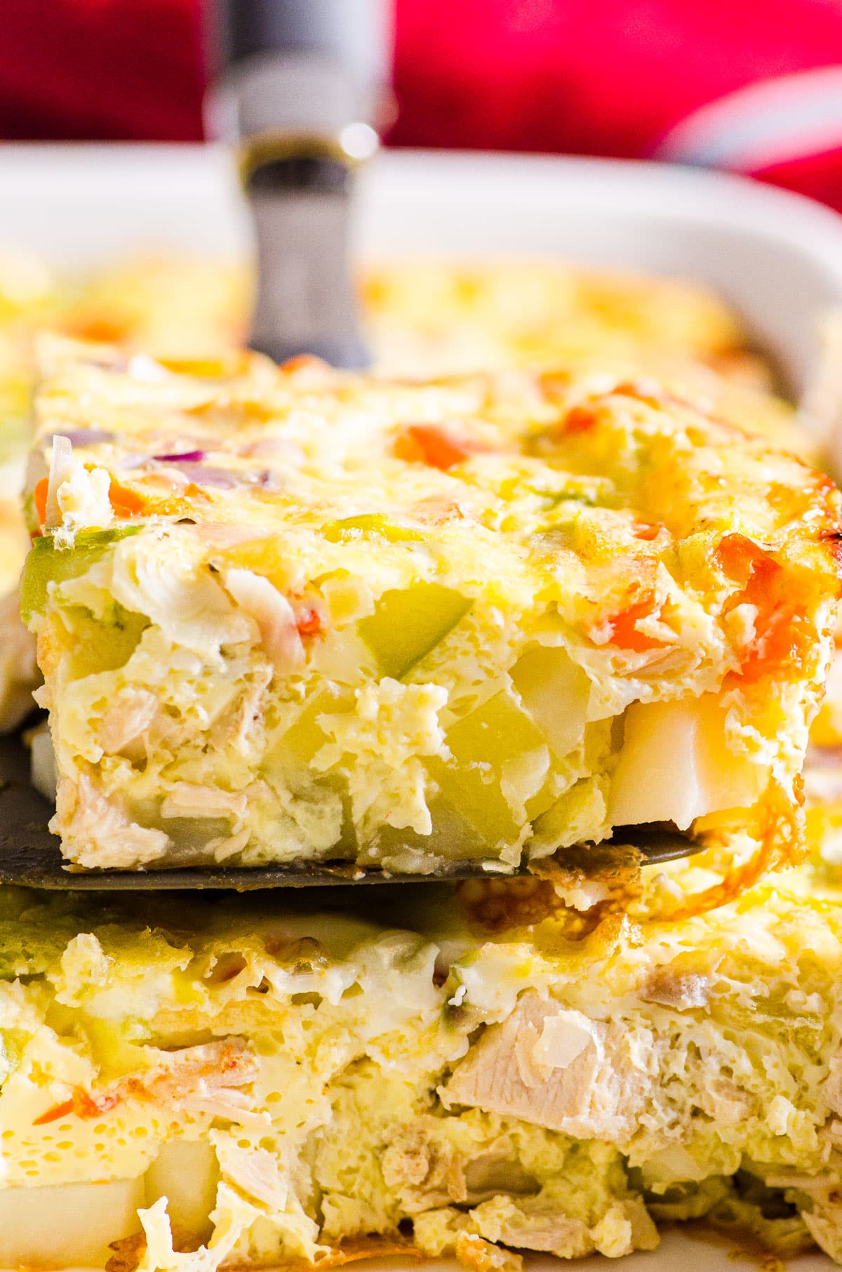 breakfast egg casserole being serving on a serving spatula out of the dish