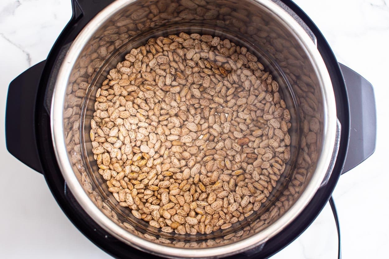 Dried pinto beans and water in Instant Pot.
