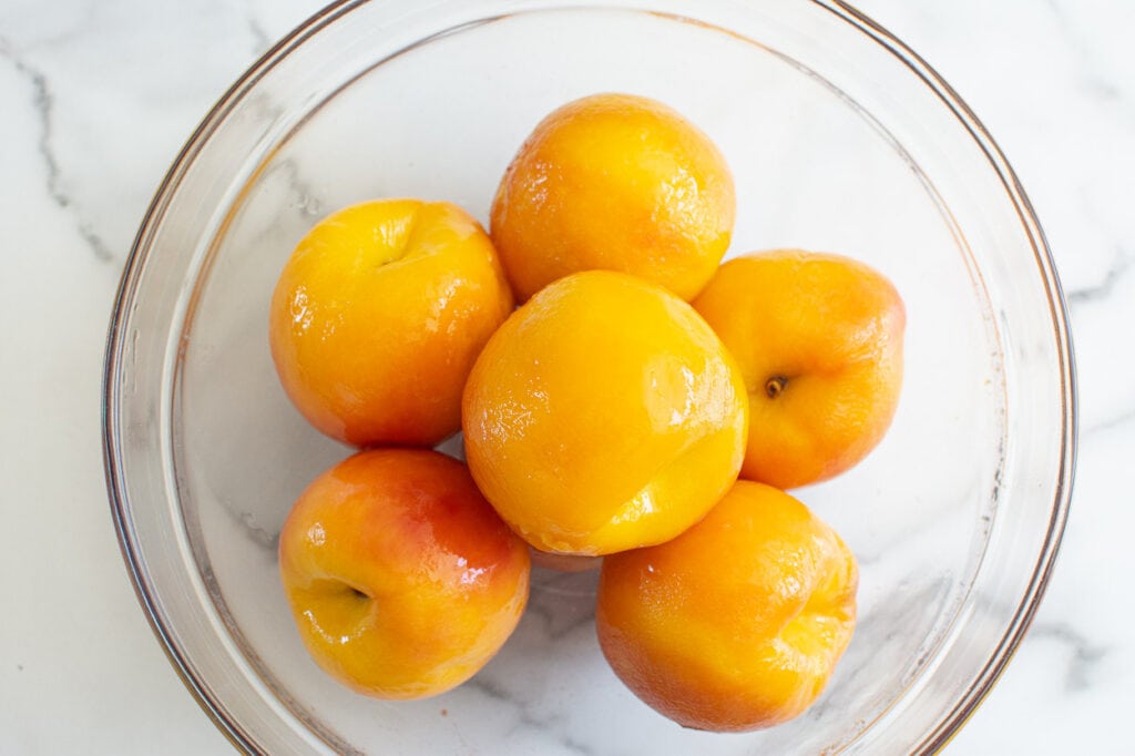 Peeled peaches in a bowl.