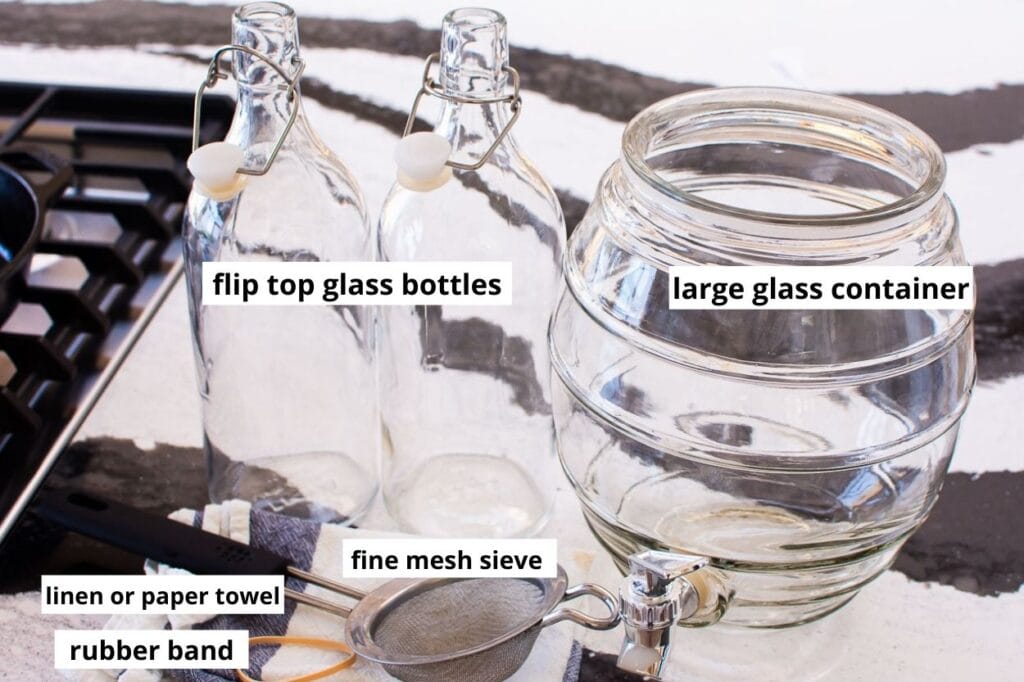 glass jar, glass bottles, mesh sieve, towel and rubber band