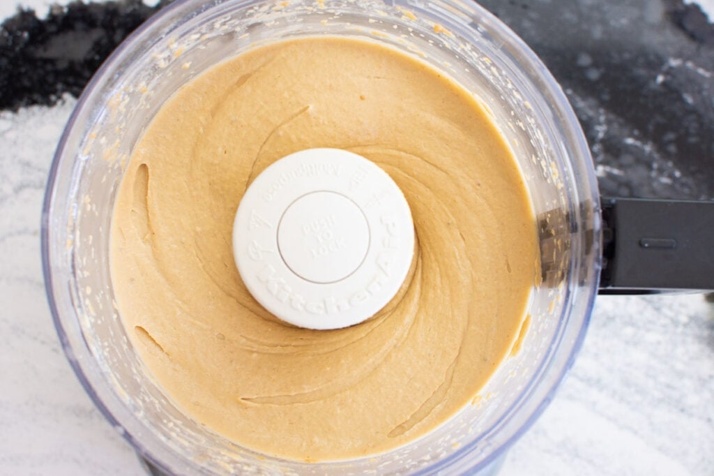 Bananas and peanut butter mixed together in food processor.
