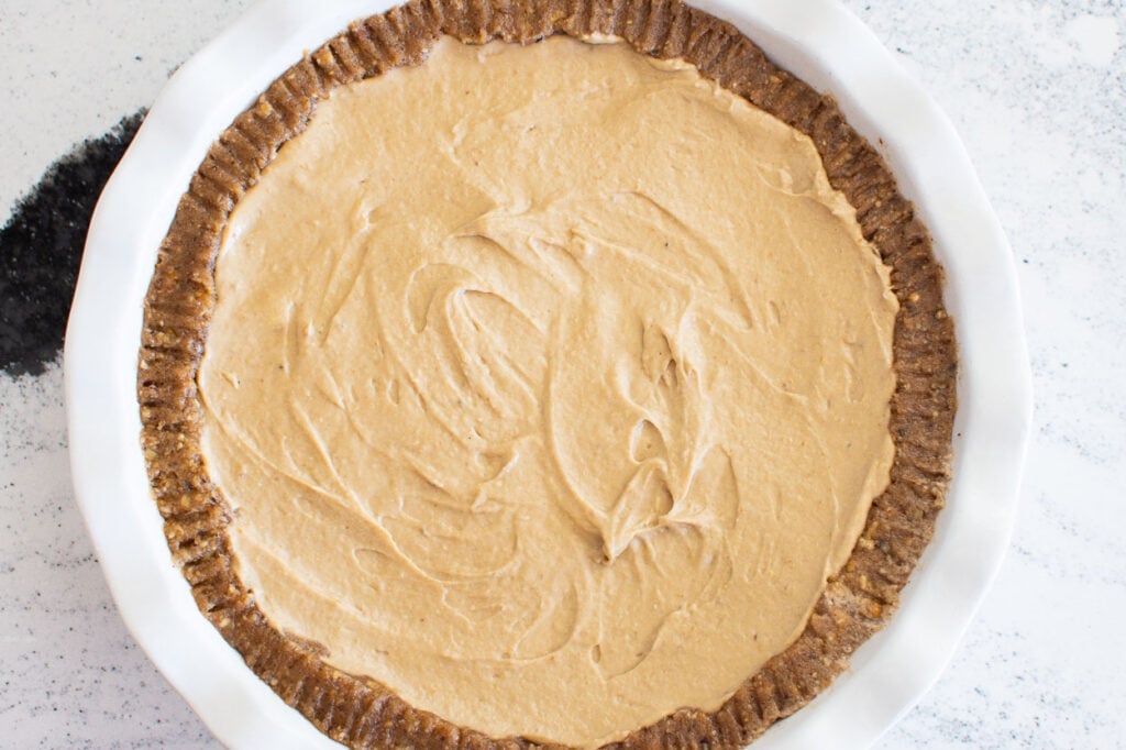 Peanut butter mixture placed over crust in pie pan. 