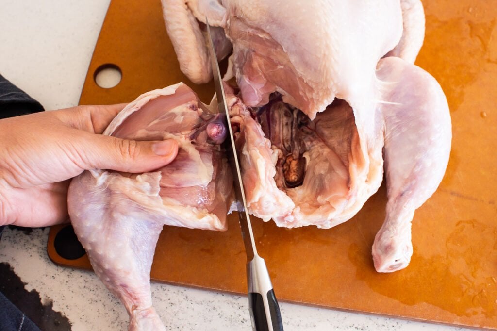 pulling legs away when cutting a whole chicken